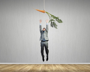 man reaching for carrot